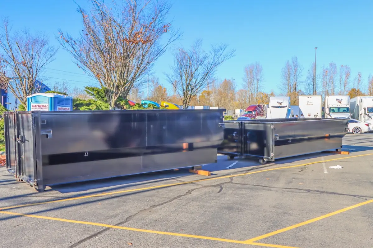 Professional dumpster rental service with roll-off container on residential driveway in Lyndhurst